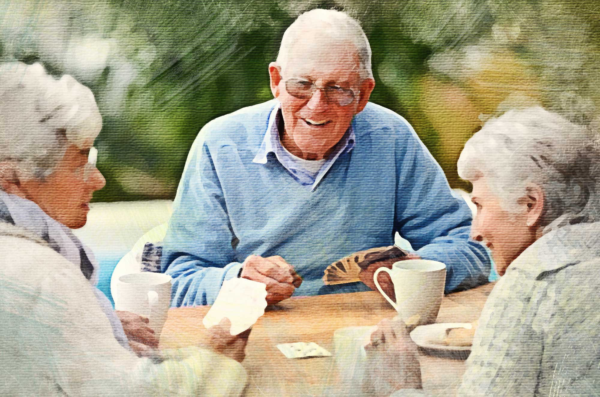 Elderly man and two elderly women playing cards.