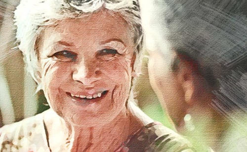 Photo of an elderly woman speaking to another elderly woman