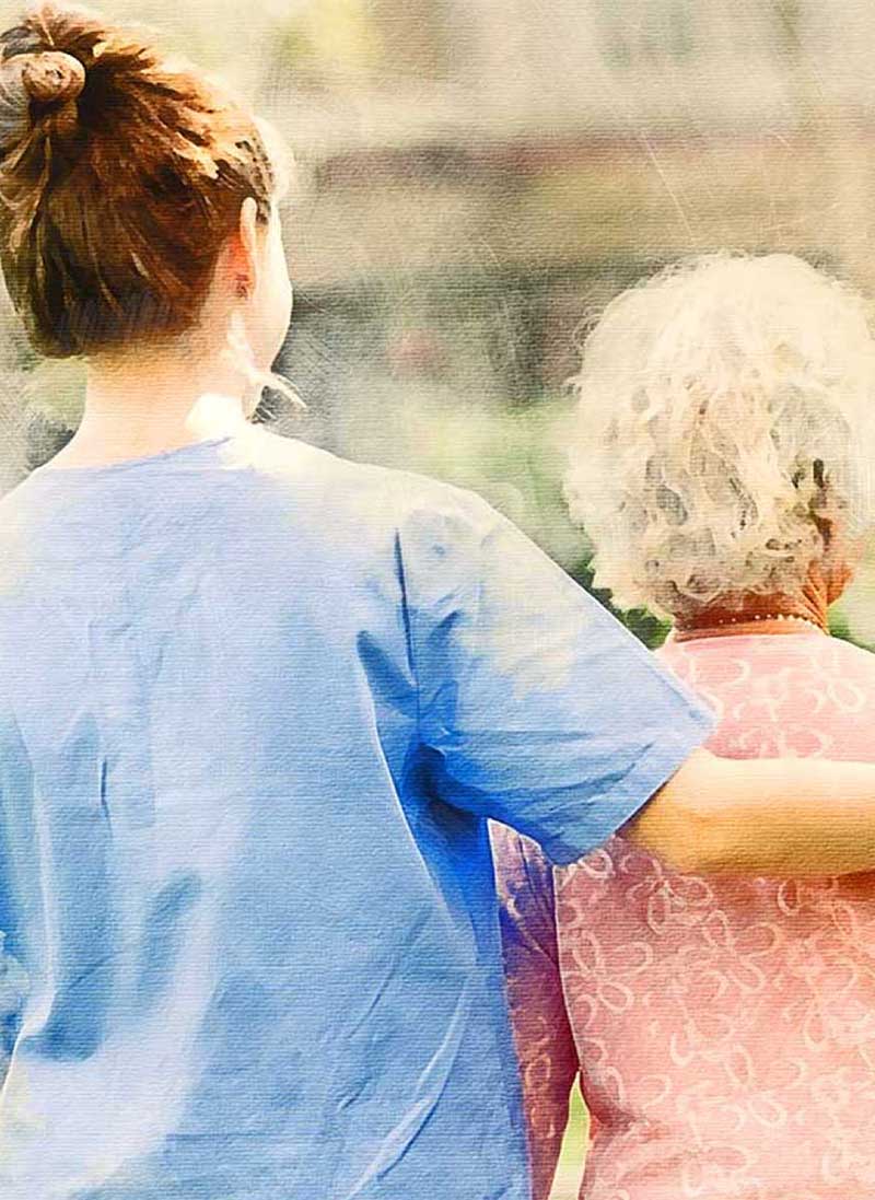 An elderly woman being led by a nurse