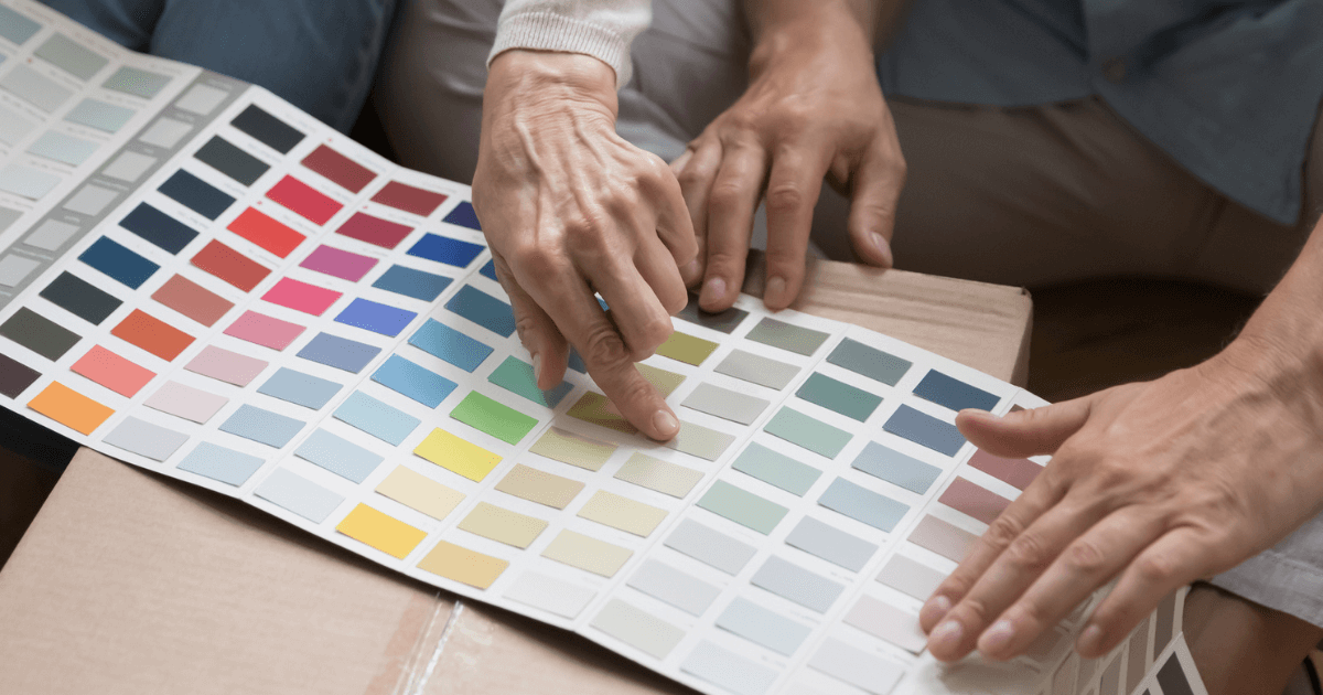 Hands pointing to paint color swatch