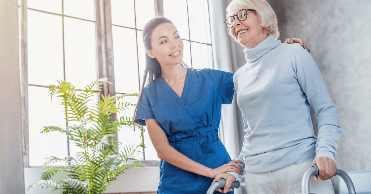 Caregiver with older woman using walker